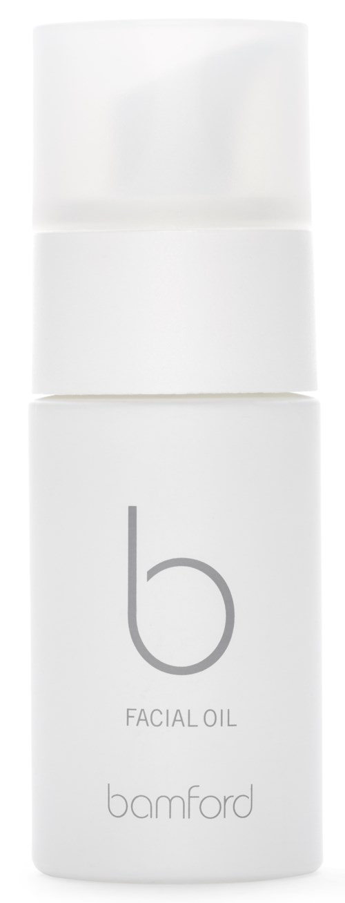 En vit flaska märkt 'bamford' med 'FACIAL OIL' under, används för hudvård.