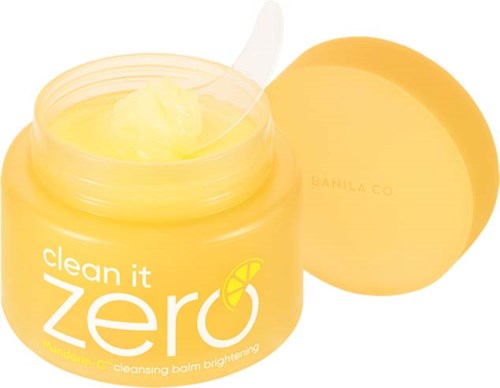 En gul krukke med hudpleieprodukt med lokk, merket "clean it zero" og en sitronskive-ikon, med innhold synlig.