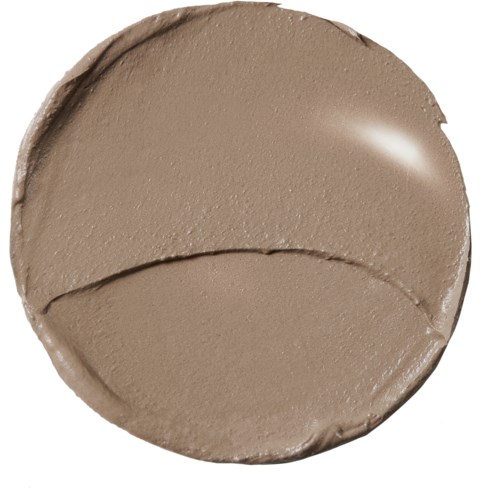 Ett runt lock för makeupbehållare med beige smink inuti, visar en slät yta och en lätt ojämn kant.