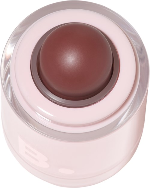 Ett brunt runt makeup-produkthölje i en genomskinlig behållare, med en rosa botten.