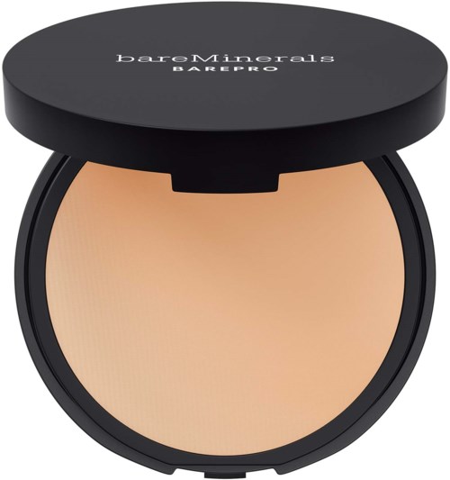 A compact round makeup product with a black lid, labeled 'bareMinerals BAREPRO', open to show beige powder inside.