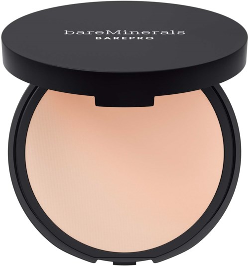 A compact with a black lid labeled 'bareMinerals BAREPRO' and a light beige pressed powder inside.