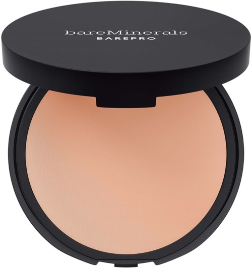 A round compact case with a black lid labeled 'bareMinerals BAREPRO,' containing beige powder makeup inside.