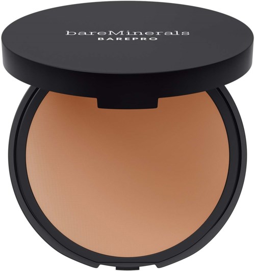 A round compact case with a black lid, containing beige pressed powder. The lid has white text saying 'bareMinerals BAREPRO.'