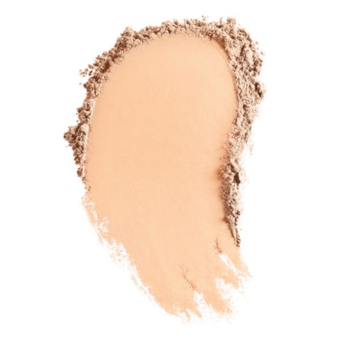 Ett beige pulver som är spritt i en ojämn form med oregelbundna kanter, liknande ett löst smink eller kosmetikprodukt.