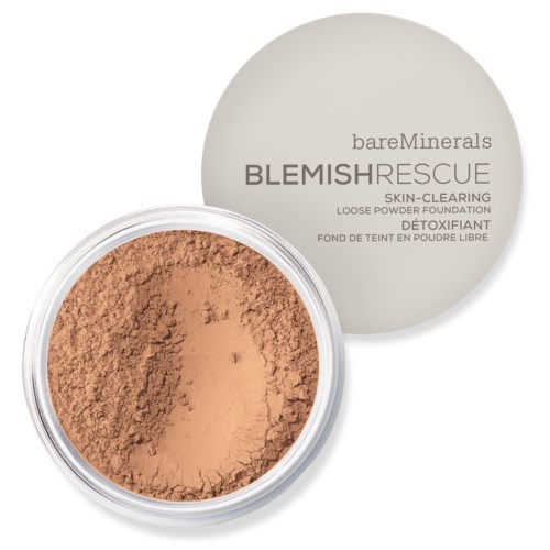 Lös pudergrund i en rund behållare, med ett ljusbeige lock som visar märke och produktnamn.
