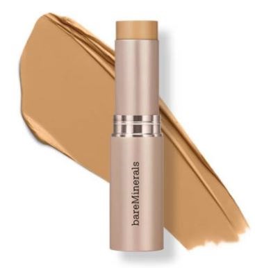 Beżowy sztyft BareMinerals z próbą produktu w tle.