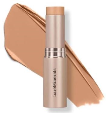 A tube of bareMinerals lipstick with a swatch of peach-colored lipstick behind it.