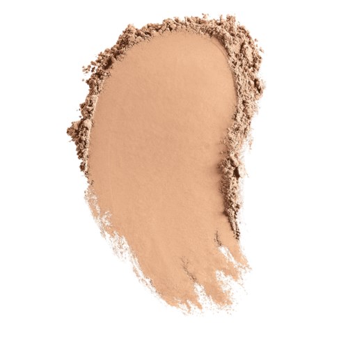 En fläck av beige pulver, lätt spredd med lösa partiklar runt kanterna.