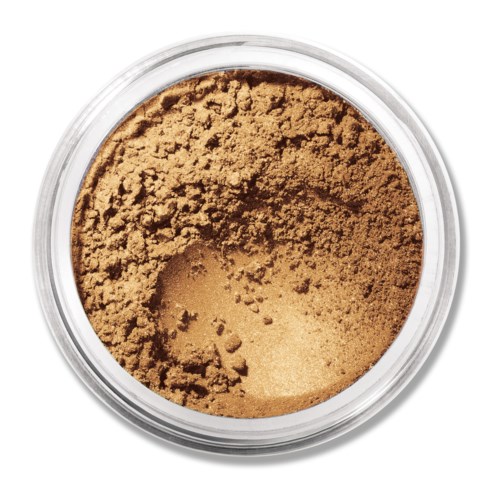 A round container with loose, light brown powder, likely makeup or powdered supplement, viewed from above.