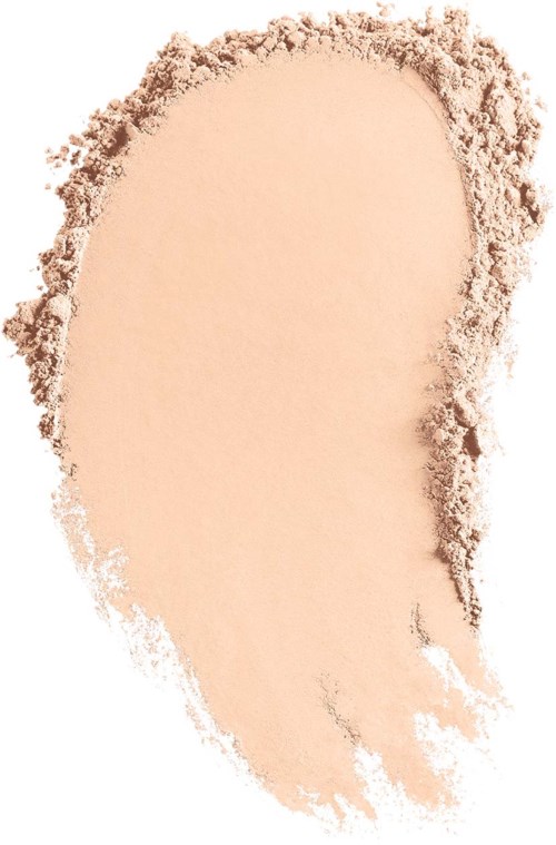 Ett ljusbeige pulver är utspritt med ojämna kanter, vissa delar mer koncentrerade och andra som försvinner.