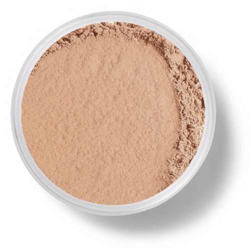 En rund beholder med beige pulver, let ujævn overflade.