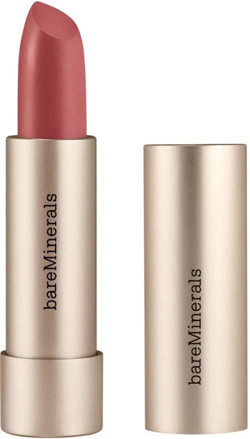 A lipstick in a beige gold tube with open cap, showing pinkish lipstick.