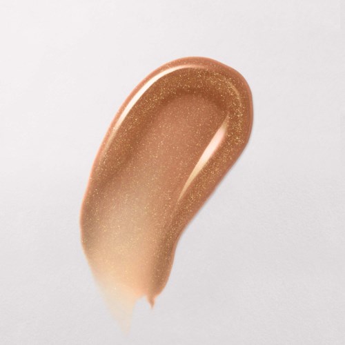 Ett provstycke av beige sminkfoundation med glittereffekt på vit bakgrund.