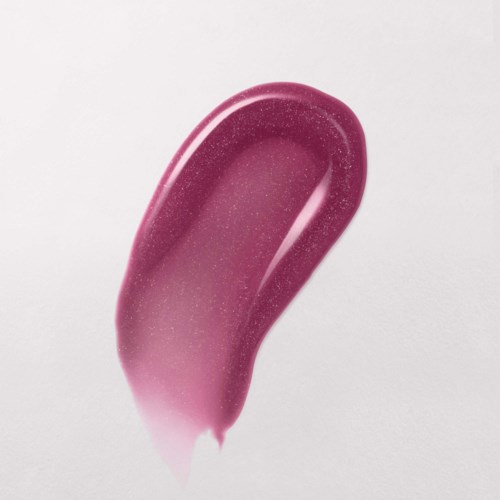 En rosa, glittrig, krökt makeupborste eller applicator mot en ljus bakgrund.