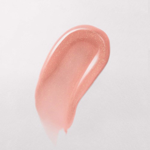 A pink, creamy makeup swatch on a white background with some sparkle.
