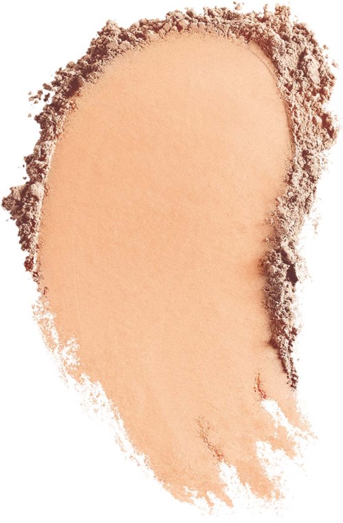 A beige powder with rough, uneven edges, possibly makeup or foundation, scattered on a white surface.