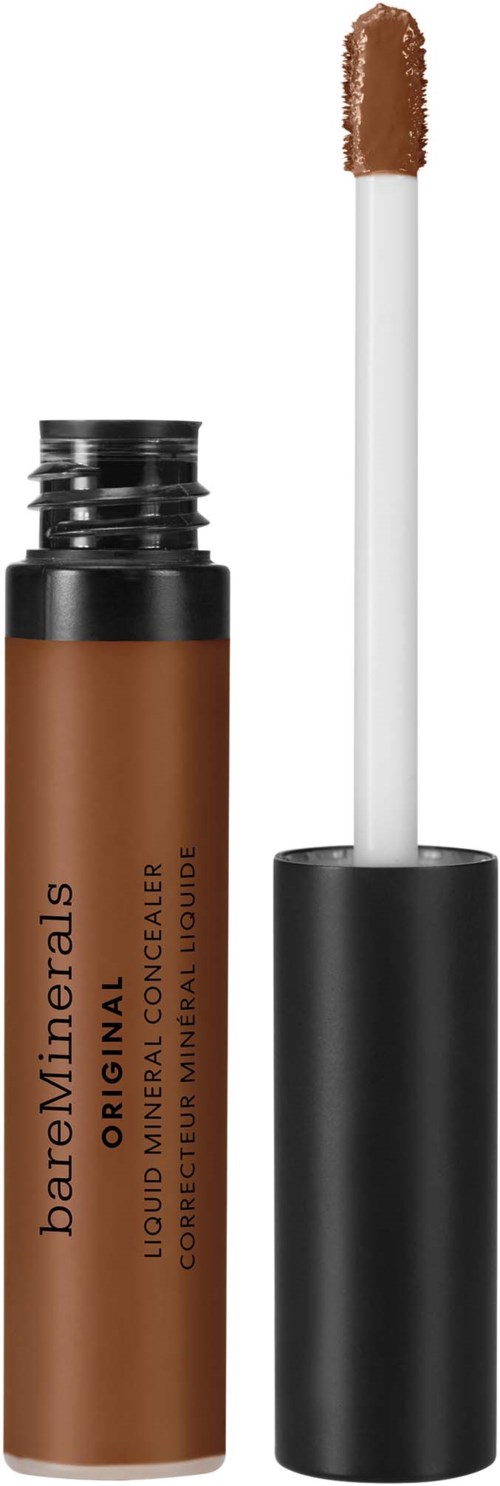 En brun flytande concealer i stiftform med en vit applikator. Applikatorhuvudet är ute ur svart cap.