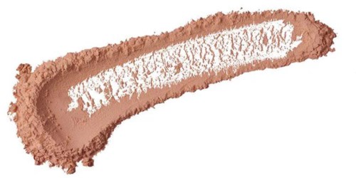 En ojämnt utbredd strimma av ljusbrun makeup eller puder med vitt inuti på en vit bakgrund.