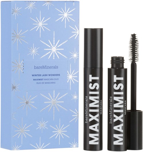 A blue box with white snowflakes, two black mascara tubes, and a mascara wand.