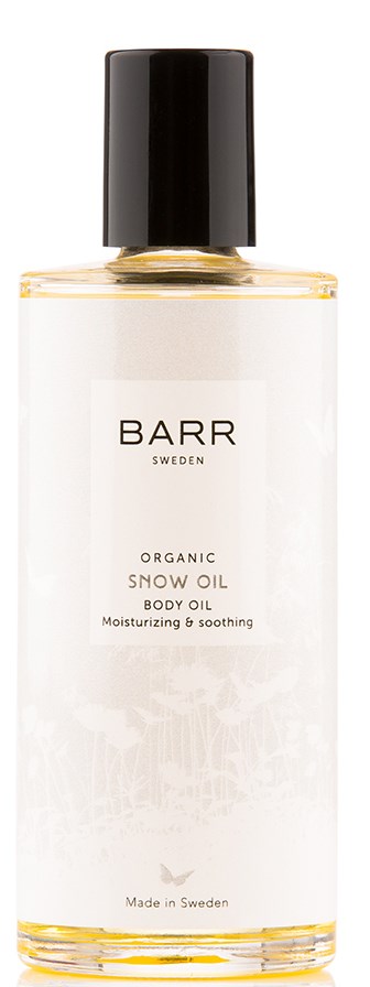 En vit flaska med svart lock, märkt 'BARR Sweden Organic Snow Oil Body Oil' för att återfuka huden.