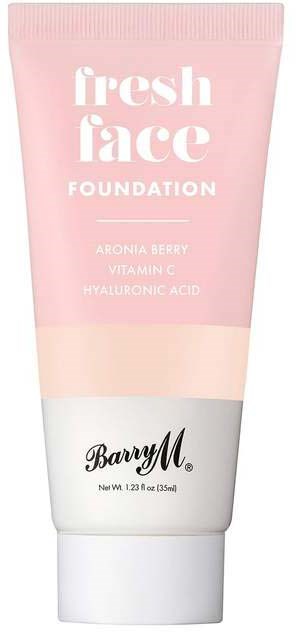 Rosa foundationrör med vit och svart text för 'fresh face' och 'Barry M'.
