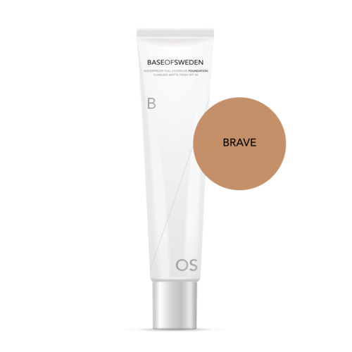 En vit tub med foundation med svart text och en ljusbrun cirkel märkt 'BRAVE'.