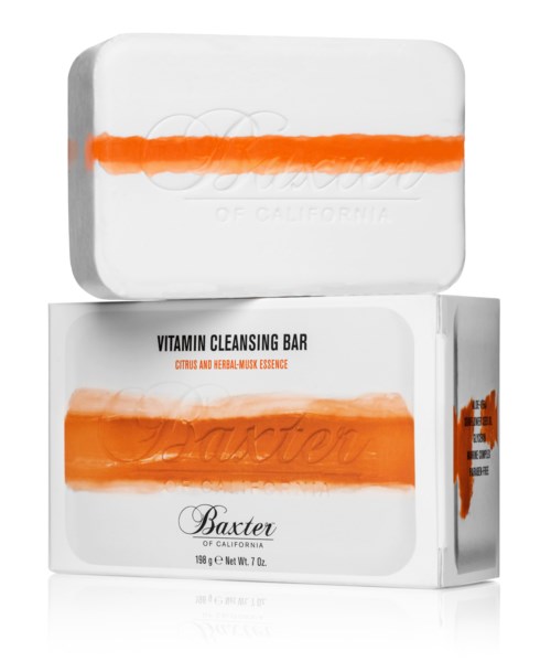 En hvit såpe med oransje striper og tekst, og en eske merket 'Vitamin Cleansing Bar, Baxter.'