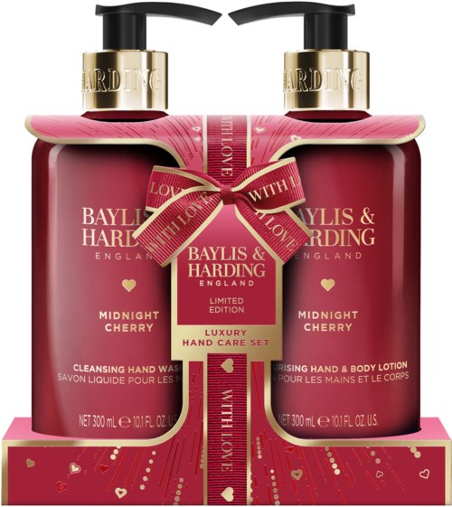 Two pink bottles of hand wash and lotion with a pink ribbon and gift box, labeled 'Luxury Hand Care Set' for Valentine's.