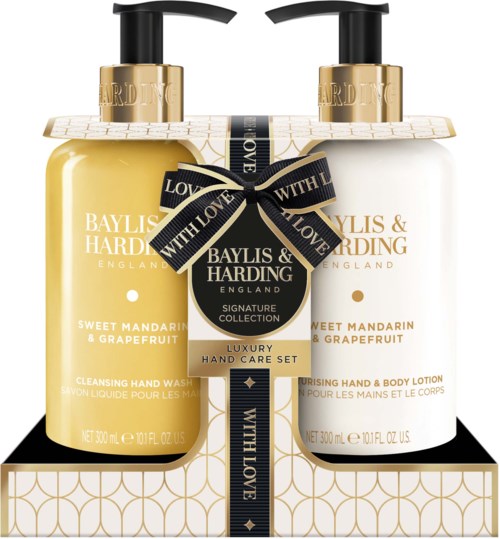 Two hand lotion bottles, one yellow and one white, with black and gold labels, tied with a black ribbon.