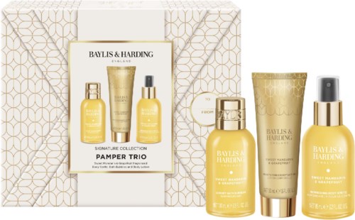 A beauty gift set with four yellow and gold skincare products, including lotion, cream, and oil, in elegant containers.