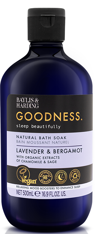 A dark blue bottle containing lavender and bergamot bath soak infused with organic extracts. Label emphasizes vegan, natural, and sleep benefits.