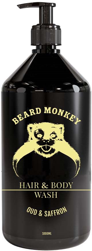 En sort flaske med pumpe, mærket 'Beard Monkey Hair & Body Wash' i gult, med en tegning af et abeansigt.