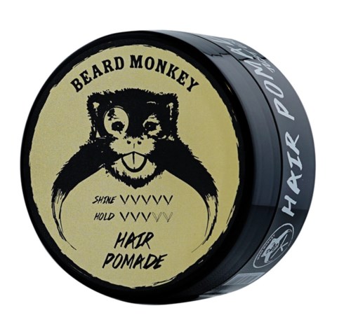 En svart burk med en beige etikett med ett bearded monkey-ansikte, varumärke och instruktioner för hårrpomad.