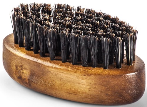 A wooden shoe brush with black bristles used for cleaning shoes.