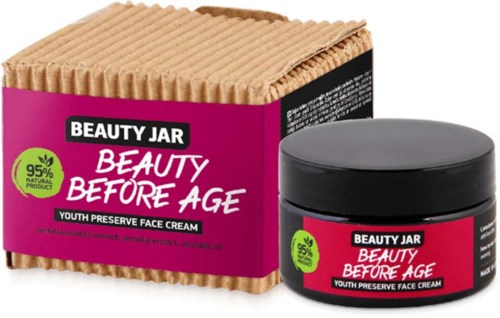 Różowa i czarna puszka z dopasowanym pudełkiem zatytułowanym 'Beauty Before Age,' promującym młodo zachowującą krem do twarzy z 95% naturalnych składników.