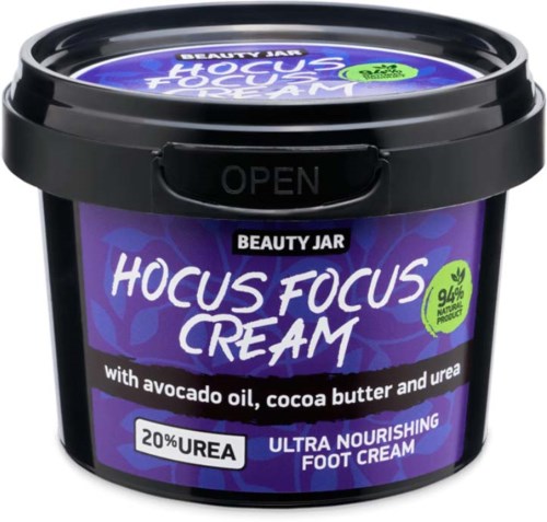 En lila och svart burk med Hocus Focus Cream med avokadoolja, kakao smör och urea för närande fötter.