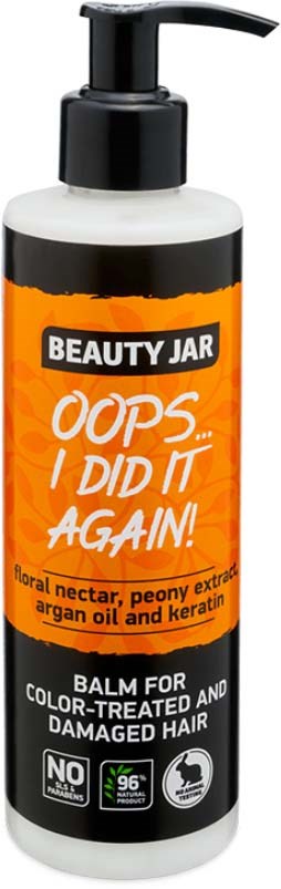 Een fles met 'Beauty Jar' label en pomp, oranje en zwart ontwerp, voor beschadigd haar met natuurlijke ingrediënten.