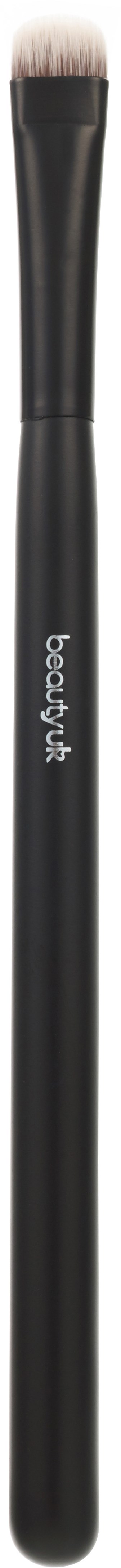 En svart makeup-borste med vita borst, märkt "beauty big bang."
