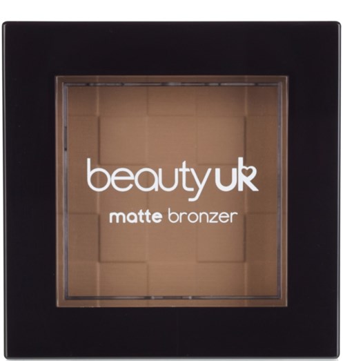 Svart kvadratisk kompakt med ett tydligt fönster som visar matt bronzer inuti. Produktnamnet finns på fönstret.
