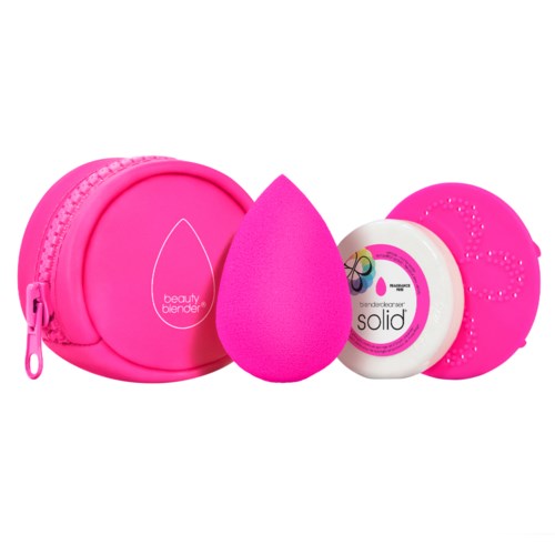 A pink beauty blender, a round container, a white round container with colorful lines, and a pink applicator.