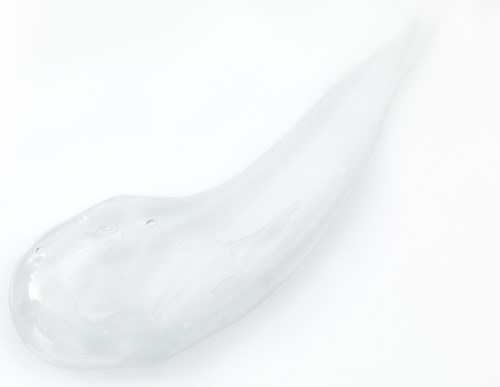 A clear gel-like substance with a smooth, shiny surface on a white background.