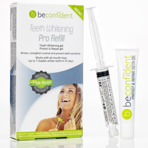 Teeth whitening gel and refill tube beside packaging, smiling woman on box, promoting dental care product.