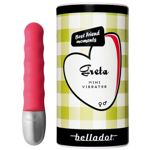En lille lyserød vibrator ved siden af emballage med grøn ternet baggrund, sort og hvid tekst, og en hjerte- og æbledesign.