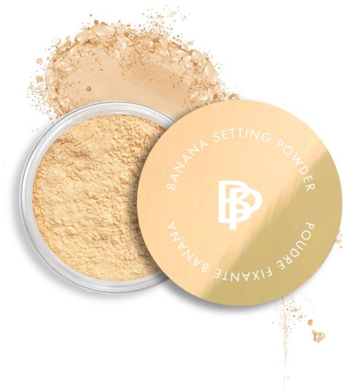 A container of banana setting powder with scattered powder around it.