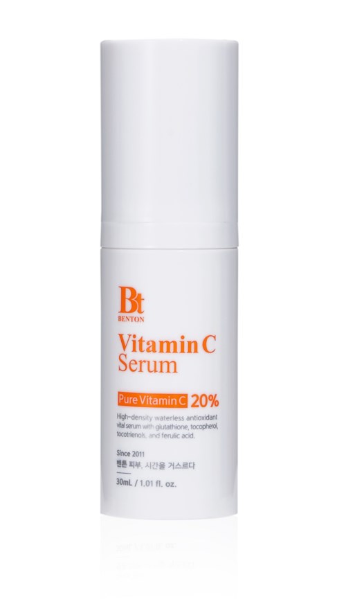 A white bottle of Vitamin C Serum with orange text, labeled 'Pure Vitamin C 20%.'