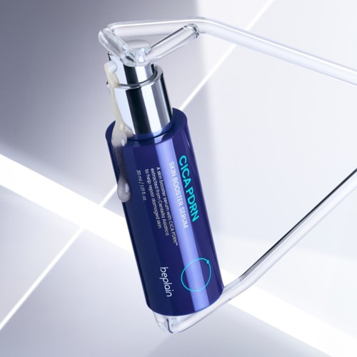 A blue bottle labeled "CICA PDRN" lying on a metallic surface with a clear plastic tube attached.