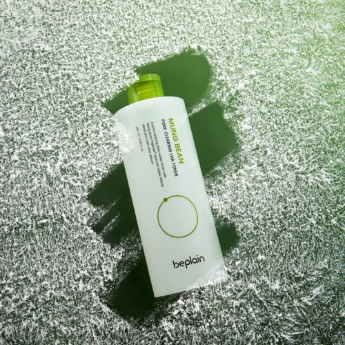 Nourishing cleansing foam from Beplain with a green cap, placed on a textured silver surface.