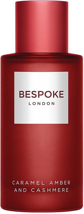 Red bottle with a white label reads 'BESPOKE London' and 'CARAMEL AMBER AND CASHMERE.'