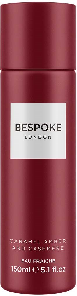 A red bottle with a white label that says 'Bespoke London' and describes a fragrance with caramel, amber, and cashmere.
